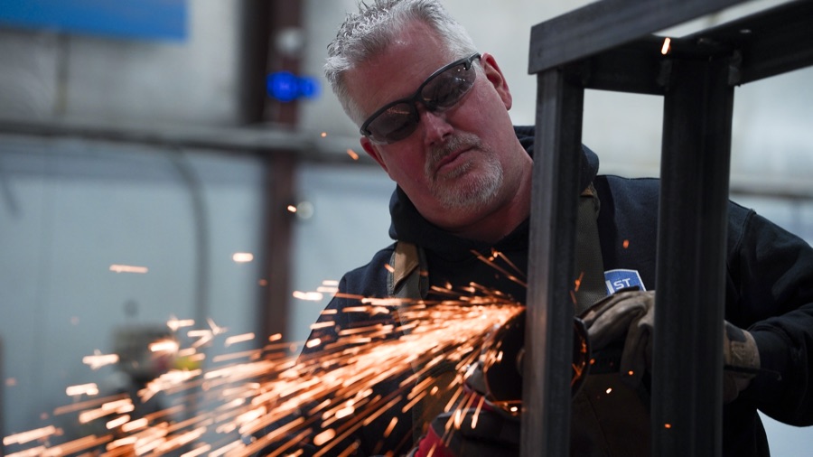Craftsman grinding metal with sparks flying at 21st Century Signs